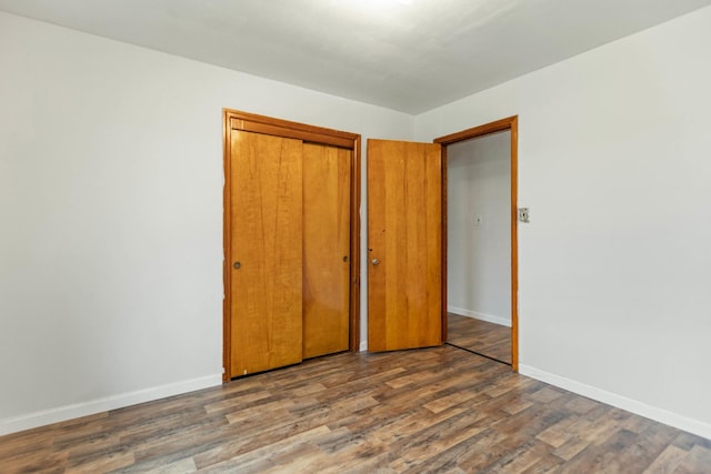 702 1st Ave, Mount Pleasant, TN 38474 - unfurnished bedroom with baseboards, wood finished floors, and a closet