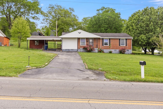 702 1st Ave, Mount Pleasant, TN 38474 - ranch-style house with brick siding, driveway, and a front yard