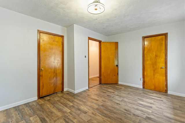 702 1st Ave, Mount Pleasant, TN 38474 - unfurnished bedroom with baseboards, a closet, and wood finished floors