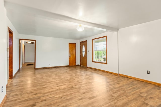 702 1st Ave, Mount Pleasant, TN 38474 - unfurnished living room with baseboards and light wood-type flooring