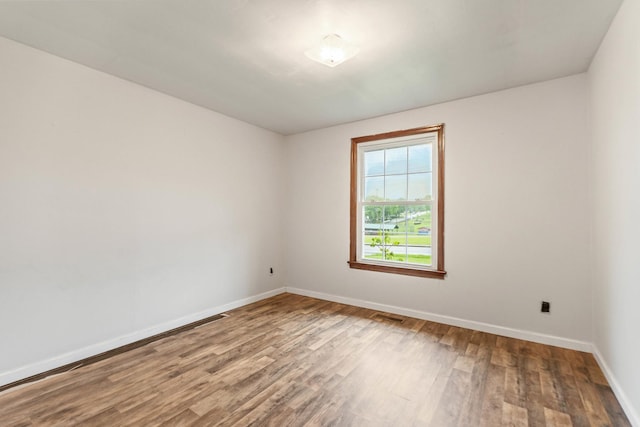 702 1st Ave, Mount Pleasant, TN 38474 - empty room with baseboards, wood finished floors, and visible vents