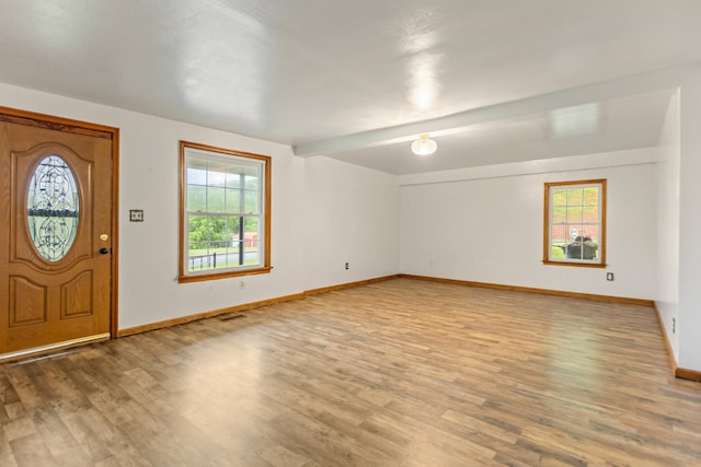 702 1st Ave, Mount Pleasant, TN 38474 - foyer featuring baseboards, light wood finished floors, and beam ceiling