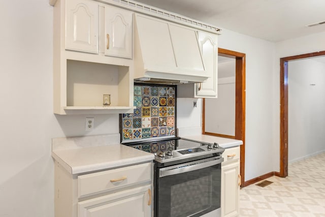 702 1st Ave, Mount Pleasant, TN 38474 - kitchen with visible vents, stainless steel range with electric stovetop, light countertops, custom exhaust hood, and light floors