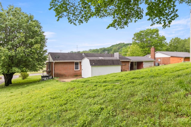 702 1st Ave, Mount Pleasant, TN 38474 - back of house with brick siding and a lawn