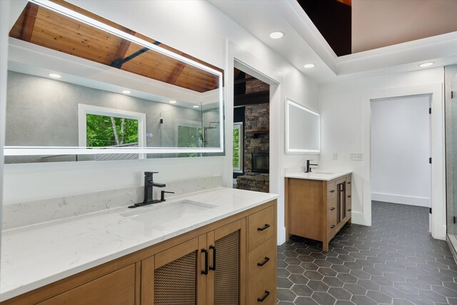 4701 Hessey Rd, Mount Juliet, TN 37122 - bathroom with a stone fireplace, a sink, two vanities, and a stall shower
