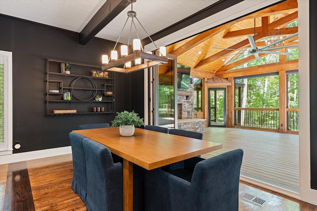 4701 Hessey Rd, Mount Juliet, TN 37122 - dining area featuring visible vents, wood finished floors, a fireplace, lofted ceiling with beams, and ceiling fan with notable chandelier