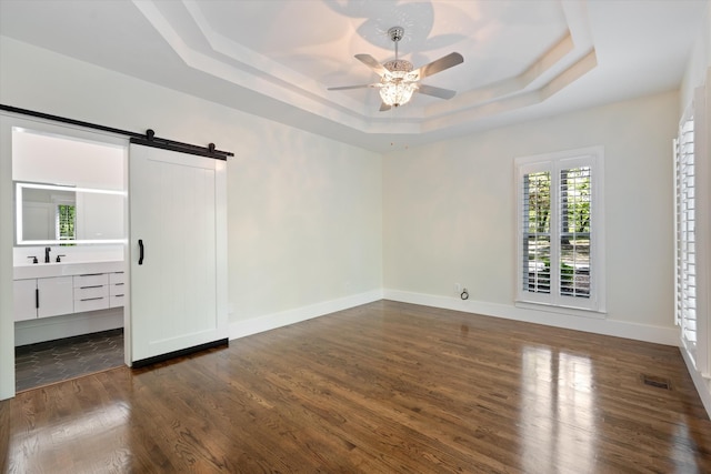 4701 Hessey Rd, Mount Juliet, TN 37122 - spare room with ceiling fan, a barn door, a raised ceiling, dark wood-type flooring, and visible vents