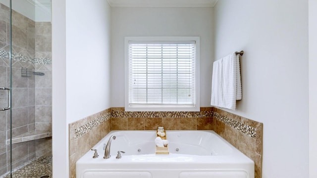 full bath with a whirlpool tub, ornamental molding, plenty of natural light, and a shower stall