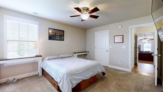 bedroom with carpet flooring, a ceiling fan, baseboards, and visible vents