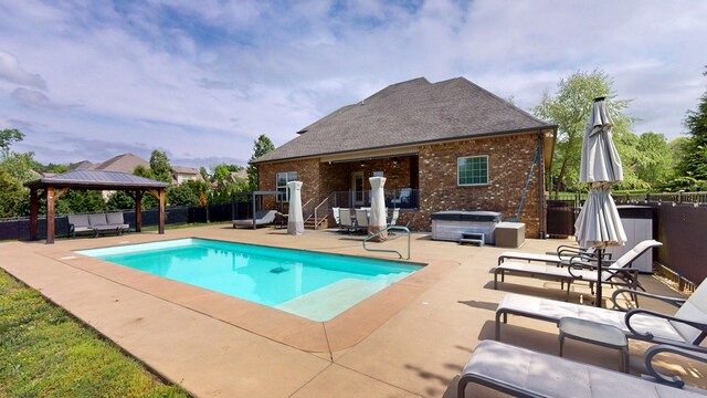 view of pool featuring a fenced backyard, a gazebo, a hot tub, and a patio area