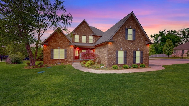 view of front of property with brick siding and a front yard