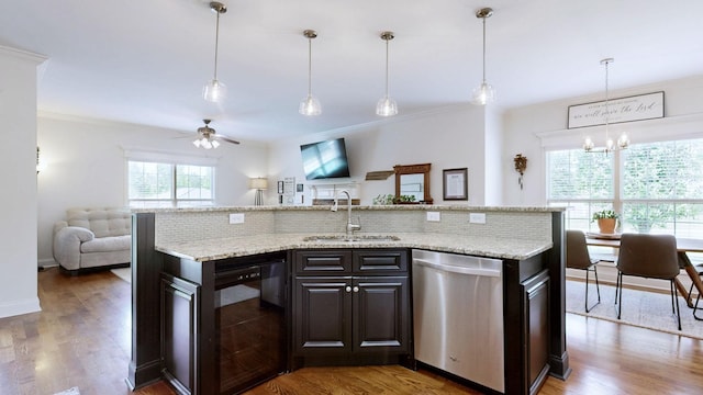 kitchen featuring wine cooler, open floor plan, a sink, ceiling fan with notable chandelier, and dishwasher