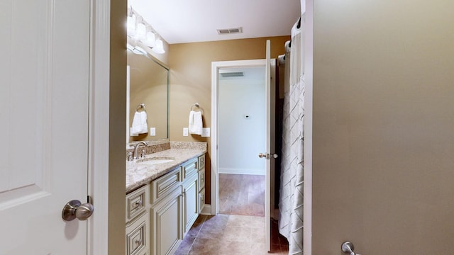bathroom featuring visible vents, tile patterned flooring, and vanity