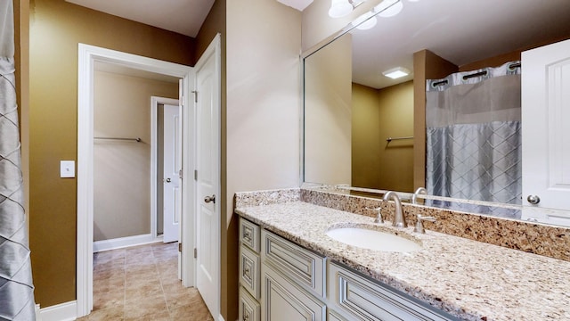 bathroom featuring vanity, baseboards, and a shower with curtain