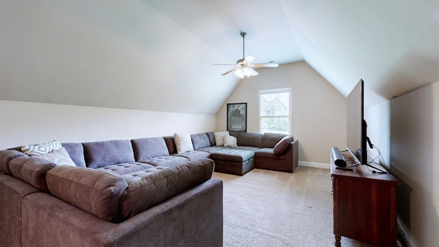 living room featuring baseboards, ceiling fan, light carpet, and vaulted ceiling