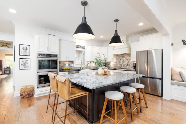743 Fontwell Ln, Franklin, TN 37064 - kitchen with plenty of natural light, appliances with stainless steel finishes, white cabinets, and a kitchen island