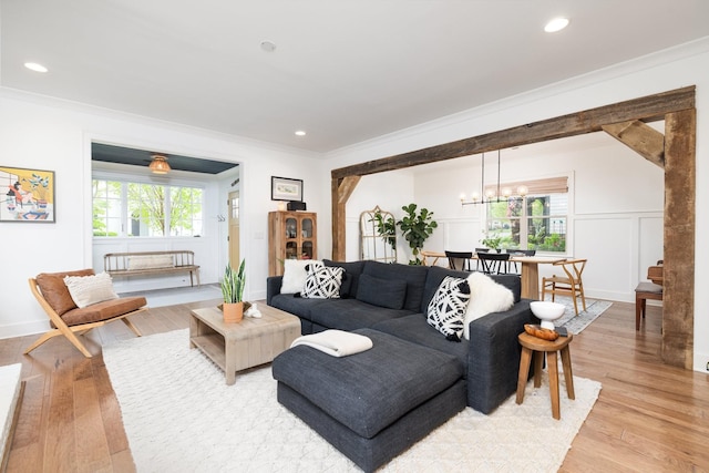 743 Fontwell Ln, Franklin, TN 37064 - living area featuring ornamental molding, a notable chandelier, light wood-type flooring, and a wealth of natural light