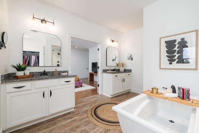 743 Fontwell Ln, Franklin, TN 37064 - full bathroom with a sink, a freestanding tub, wood finished floors, and two vanities