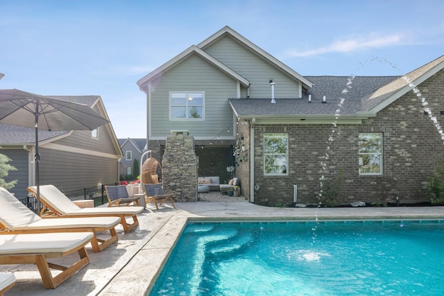 743 Fontwell Ln, Franklin, TN 37064 - rear view of property featuring outdoor lounge area, an outdoor pool, roof with shingles, brick siding, and a patio area