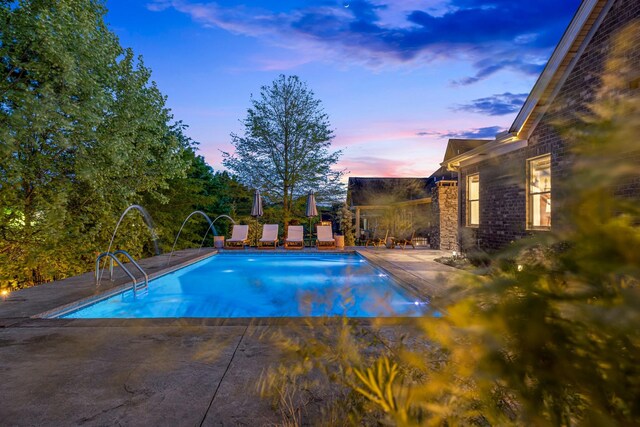 743 Fontwell Ln, Franklin, TN 37064 - pool at dusk featuring a patio and an outdoor pool