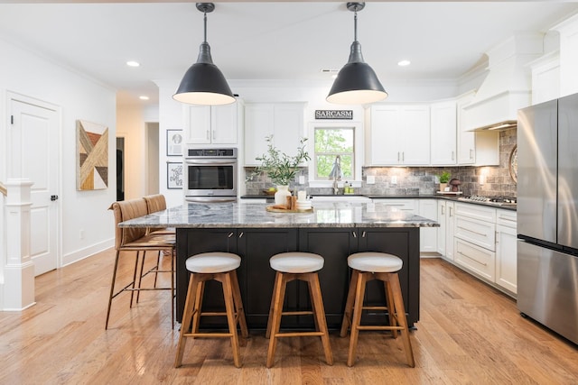 743 Fontwell Ln, Franklin, TN 37064 - kitchen featuring a center island, white cabinetry, backsplash, and stainless steel appliances
