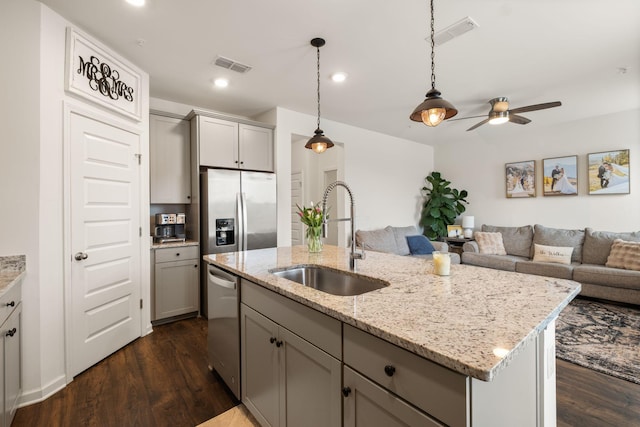 kitchen featuring visible vents, a sink, gray cabinetry, and stainless steel appliances
