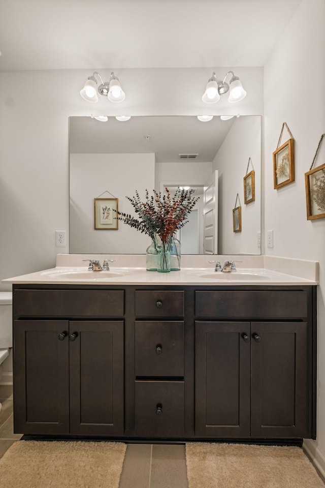 full bathroom featuring double vanity and a sink