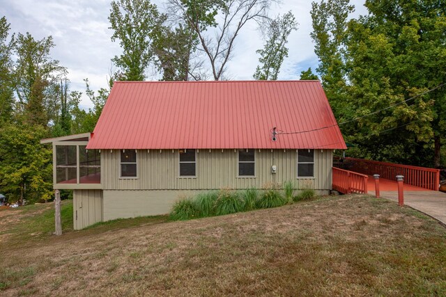 4428 Deer Creek Rd, Linden, TN 37096 - view of side of property with a lawn, a sunroom, and metal roof