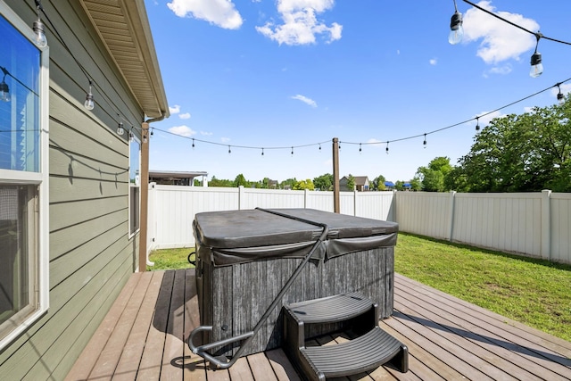 wooden terrace featuring a fenced backyard and a hot tub