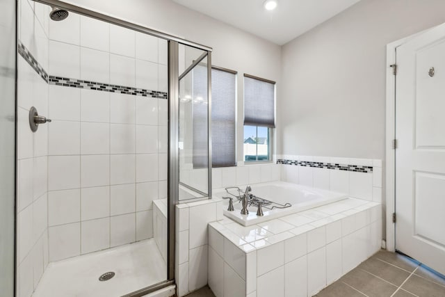 bathroom with tile patterned floors, a stall shower, recessed lighting, and a garden tub