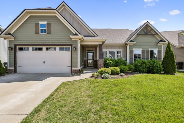 craftsman house with board and batten siding, driveway, roof with shingles, a front yard, and central air condition unit