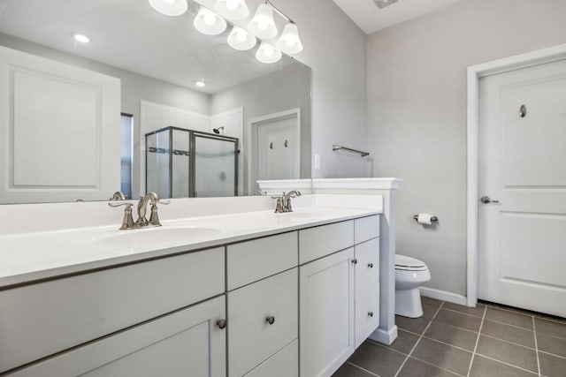 full bath with a sink, tile patterned flooring, double vanity, toilet, and a stall shower
