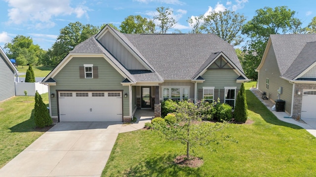 craftsman-style house featuring roof with shingles, board and batten siding, driveway, and a front lawn