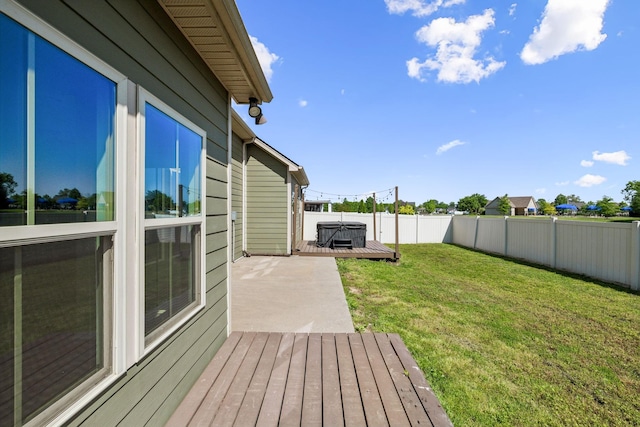 view of yard with a fenced backyard, a hot tub, and a deck