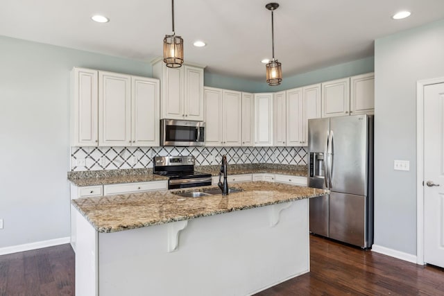 kitchen with backsplash, stainless steel appliances, baseboards, and dark wood finished floors