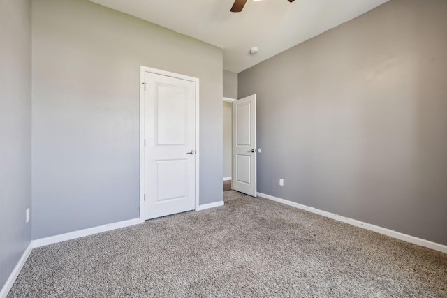 unfurnished bedroom featuring baseboards, carpet, and ceiling fan