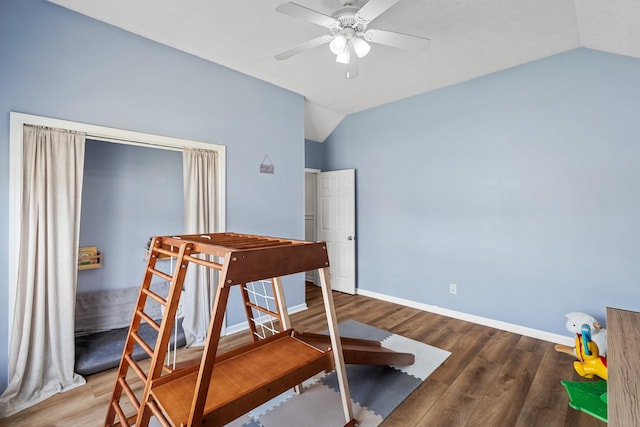 bedroom featuring ceiling fan, baseboards, vaulted ceiling, and wood finished floors