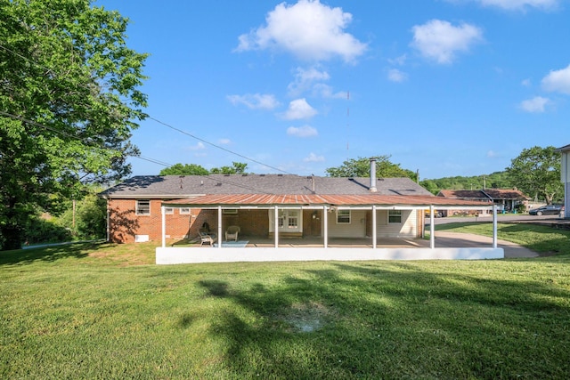 6505 Firestone Ct, Nashville, TN 37209 - rear view of property featuring a lawn, a patio area, and brick siding