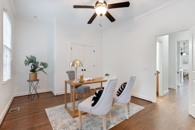 office area with crown molding, a ceiling fan, dark wood finished floors, and a healthy amount of sunlight