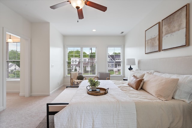 bedroom featuring ceiling fan, visible vents, baseboards, light carpet, and recessed lighting
