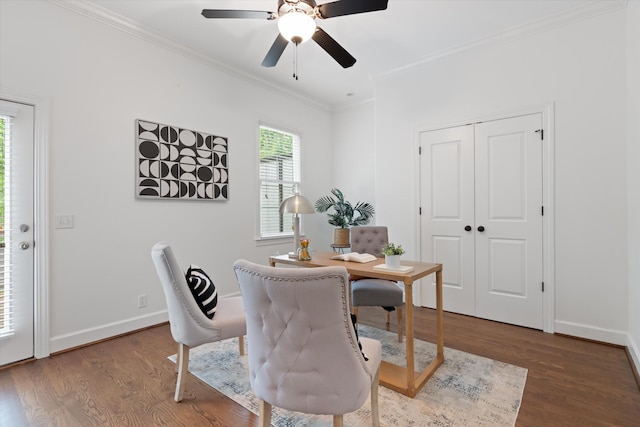 dining space with baseboards, ornamental molding, ceiling fan, and wood finished floors