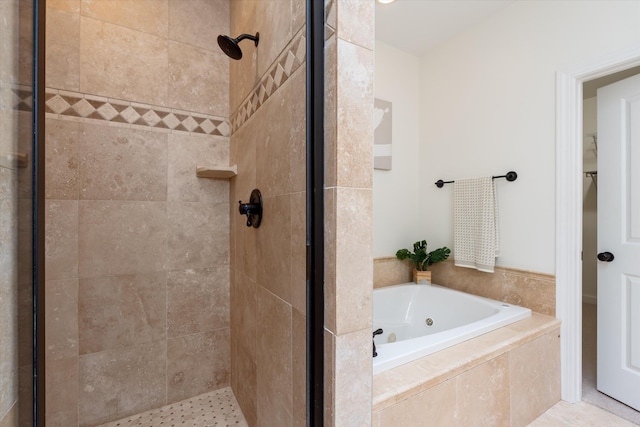 bathroom with a shower stall and a tub with jets