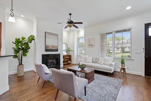living area with ceiling fan, dark wood-style flooring, a high end fireplace, crown molding, and recessed lighting