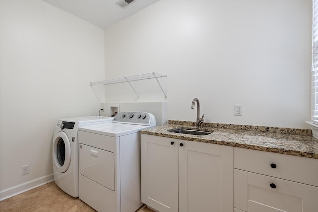laundry area with washer and dryer, laundry area, a sink, baseboards, and visible vents