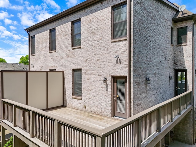 rear view of house featuring brick siding