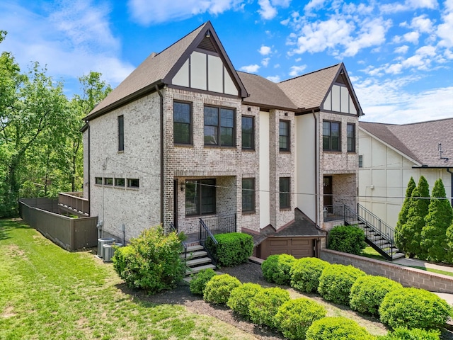 view of front of property with brick siding and a front lawn