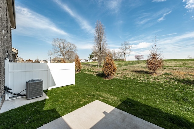 view of yard with fence, a patio, and cooling unit