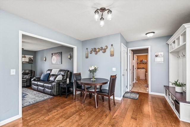 dining room featuring baseboards and hardwood / wood-style flooring