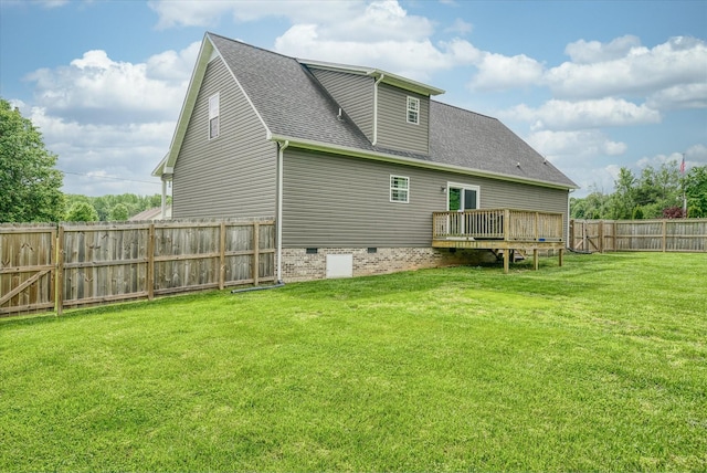 rear view of house with a wooden deck, a fenced backyard, a shingled roof, crawl space, and a yard