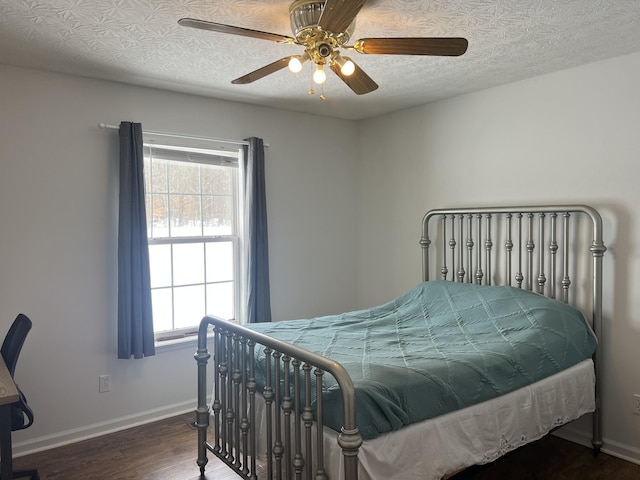 bedroom with baseboards, ceiling fan, and wood finished floors